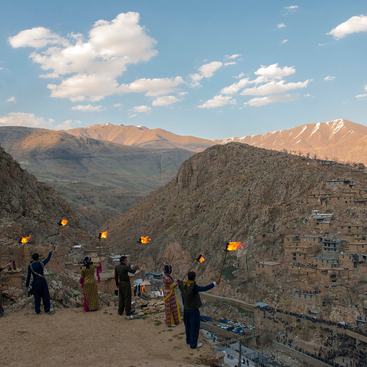 People in the mountains conducting a ceremony.