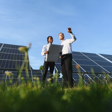 Engineers in front of solar panels