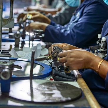african workers, diamond polisher at work, using a polishing wheel to shape and refine a rough diamond, brillianteering