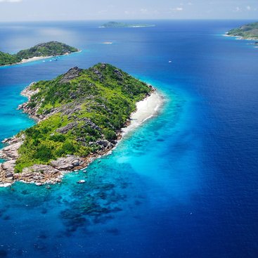 Ariel view of the Seychelles in the Indian Ocean - small islands with white beaches surrounded by bright azure water.